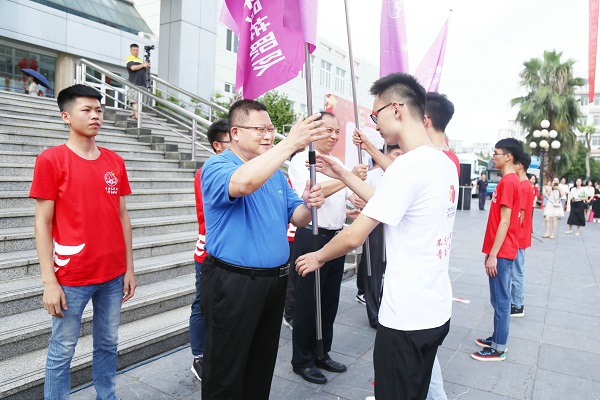 校领导为实践队伍代表授旗.jpg