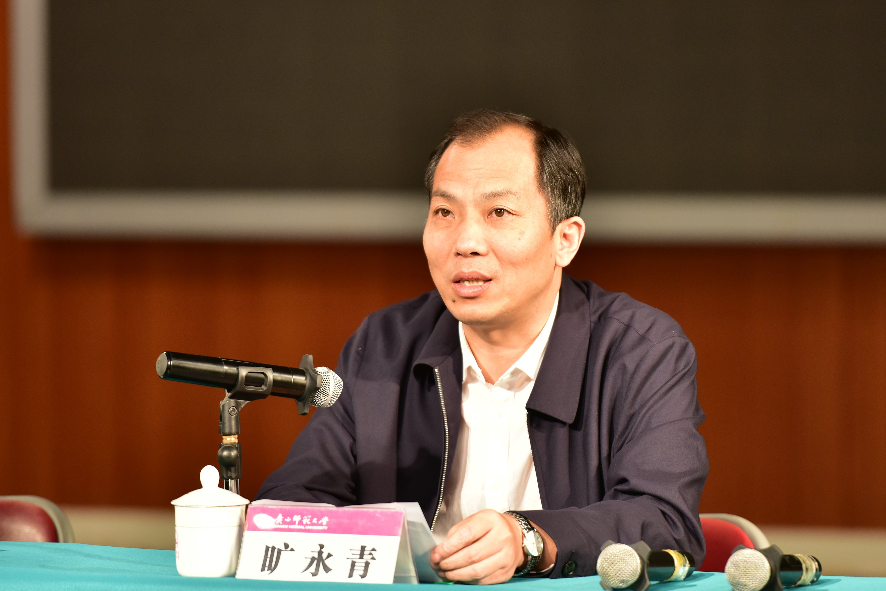 旷永青主持报告会.JPG