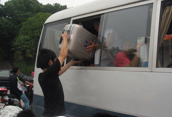 帮助新生搬行李下车。