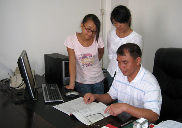 百色高中特级教师韦贵方校友向访谈学生介绍新教材。