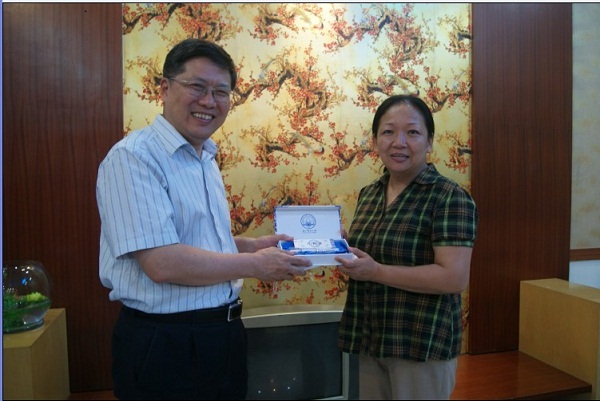 王枬书记(右)向汤敏博士赠送学校的纪念品