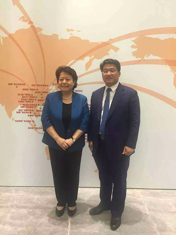 自治区党委常委、统战部部长李康（左）与卢爱任校友（右）合影